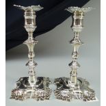 PAIR OF GEORGE II CAST SILVER CANDLESTICK HOLDERS with decorative bases and knopped stems, removable