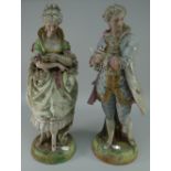 PAIR OF TALL BISQUE PORCELAIN FIGURES IN REGENCY COSTUME standing against tree stumps,