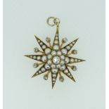YELLOW METAL DIAMOND AND PEARL STARBURST DESIGN PENDANT set with graduated seed pearls and