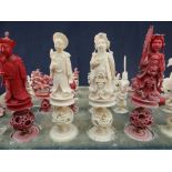CHINESE IVORY CHESS MEN in natural and red-stained ivory, carved as emperors, horseback warriors,