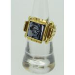 YELLOW METAL INTAGLIO RING depicting the head of a Roman legionnaire, (tested as high carat