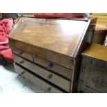 ANTIQUE MAHOGANY DROP-DOWN BUREAU with two short, two long drawer base