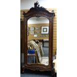 ANTIQUE FRENCH MIXED WOOD ARMOIRE carved in the Rococo style with scroll supports and large shaped