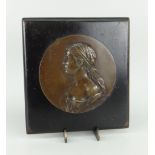 CIRCULAR BRONZE PORTRAIT PLAQUE mounted to an ebonized wooden hanging board, the bronze indistinctly