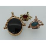 THREE 9CT GOLD REVOLVING FOBS SET WITH VARIOUS STONES, 15.8gms overall