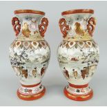PAIR OF TWIN HANDLED KUTANI BALUSTER VASES with twin floral handles, decorated with wildlife and
