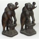 PAIR OF CARVED FLOOR STANDING INDIAN ELEPHANTS, both with trunk curled upwards and front hooves
