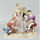 CONTINENTAL PORCELAIN GROUP OF FOUR FIGURES on naturalistic scrolling base, 18cms high