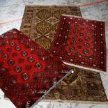TWO RED GROUND GEOMETRIC PATTERNED AFGHAN WOOLEN RUGS, 114 x 79cms and 114 x 76cms, together with