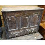 GOOD 20TH CENTURY OAK COFFER BACH carved with three panels and with two lower drawers, 68cms wide