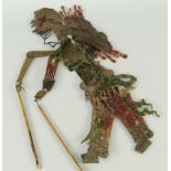 CHINESE BUFFALO HIDE DYED SHADOW PUPPET in the form of a figure in ornate costume, 33cms high