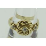 18CT YELLOW GOLD DIAMOND SET KNOT DESIGN RING, 4.9gms.