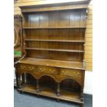 20TH CENTURY OAK WELSH DRESSER having an open base with arched frieze, three drawers and open