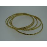 FIVE YELLOW METAL INDIAN DOWRY LADIES BANGLES (tested as high carat approximately 22ct gold), 57