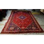WOOLEN PERSIAN SHIRAZ RUG in mainly red and blue ground with geometric pattern and contrasting