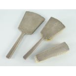 THREE PIECE ART DECO SILVER VANITY SET comprising hairbrush, clothes-brush and vanity-mirror, each