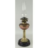 ANTIQUE OIL LAMP WITH ART NOUVEAU STYLE BRASS STEM, circular black glass base, copper reservoir