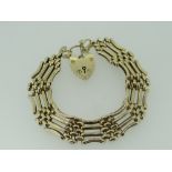 9CT YELLOW GOLD FOUR BAR GATE BRACELET WITH HEART SHAPED PADLOCK, 29.1gms, 20cms long.