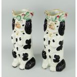 PAIR OF STAFFORDSHIRE BEGGING SPANIEL SPILL HOLDERS with loop handles, black and white glaze, 19th