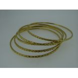 FIVE YELLOW METAL INDIAN DOWRY BANGLES (tested as high carat approximately 22ct gold), 56.8 grams (