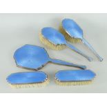 SILVER & GUILLOCHE BLUE ENAMEL FIVE-PIECE VANITY SET comprising pair of hairbrushes, pair of