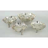 GRADUATED SET OF FOUR SILVER BON-BON DISHES each on three leaf-form feet with decorative open-work