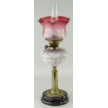 ANTIQUE BRASS & BLACK GLASS BASED OIL LAMP, floral vaseline glass reservoir, tinted cranberry and