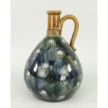 ROYAL DOULTON STONEWARE GLOBULAR LOOP HANDLED VASE decorated with tube lined floral design,