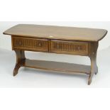 ERCOL LONG JOHN COFFEE TABLE of rounded rectangular form, two fluted drawers with turned knobs and