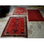THREE VARIOUS PERSIAN WOOLEN RUGS, all mainly red ground with various patterns, 130 x 102cms, 150