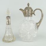 SILVER & CUT-GLASS CLARET JUG of oval form, having a silver loop handle to a scroll decorated collar