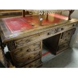 GOOD VINTAGE OAK DESK with arrangement of eight drawers, tooled leather top, 137cms wide x 80cms