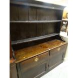 ANTIQUE PRIMITIVE DRESSER having a closed base with two cupboards and two drawers, two shelf boarded
