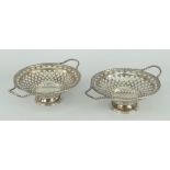 PAIR OF DELICATE SILVER TWIN-HANDLED BASKETS with twist handles to twist rim, pierced bodies,