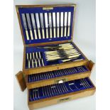 VINTAGE OAK CANTEEN OF BONE HANDLE MONOGRAMMED CUTLERY, two base drawers and hinged lid, seemingly