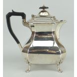 SILVER COFFEE-POT of faceted form on four claw feet, ebonised handle and knop, Sheffield 1926, 21ozs