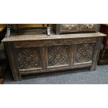 19TH CENTURY CARVED OAK BLANKET CHEST having three floret carved panels and carves frieze, 132cms