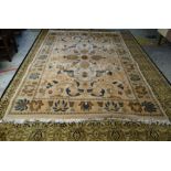 MAINLY GREEN & GOLD GROUND PERSIAN RUG with centre decoration and contrasting border, 341 x