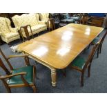 VICTORIAN MAHOGANY EXTENDING DINING TABLE on reeded and turned supports with casters, to accommodate