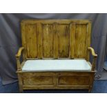 CIRCA 1820 BOX SEAT PINE SETTLE with swept arms and four panel back, 133cms height, 144cms width,