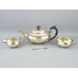THREE PIECE SILVER TEA SERVICE - each of oval plain form with beadwork rims and on four shell and