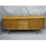 MID-CENTURY TEAK LONG SIDEBOARD of four central drawers and twin drop down flanking cupboard