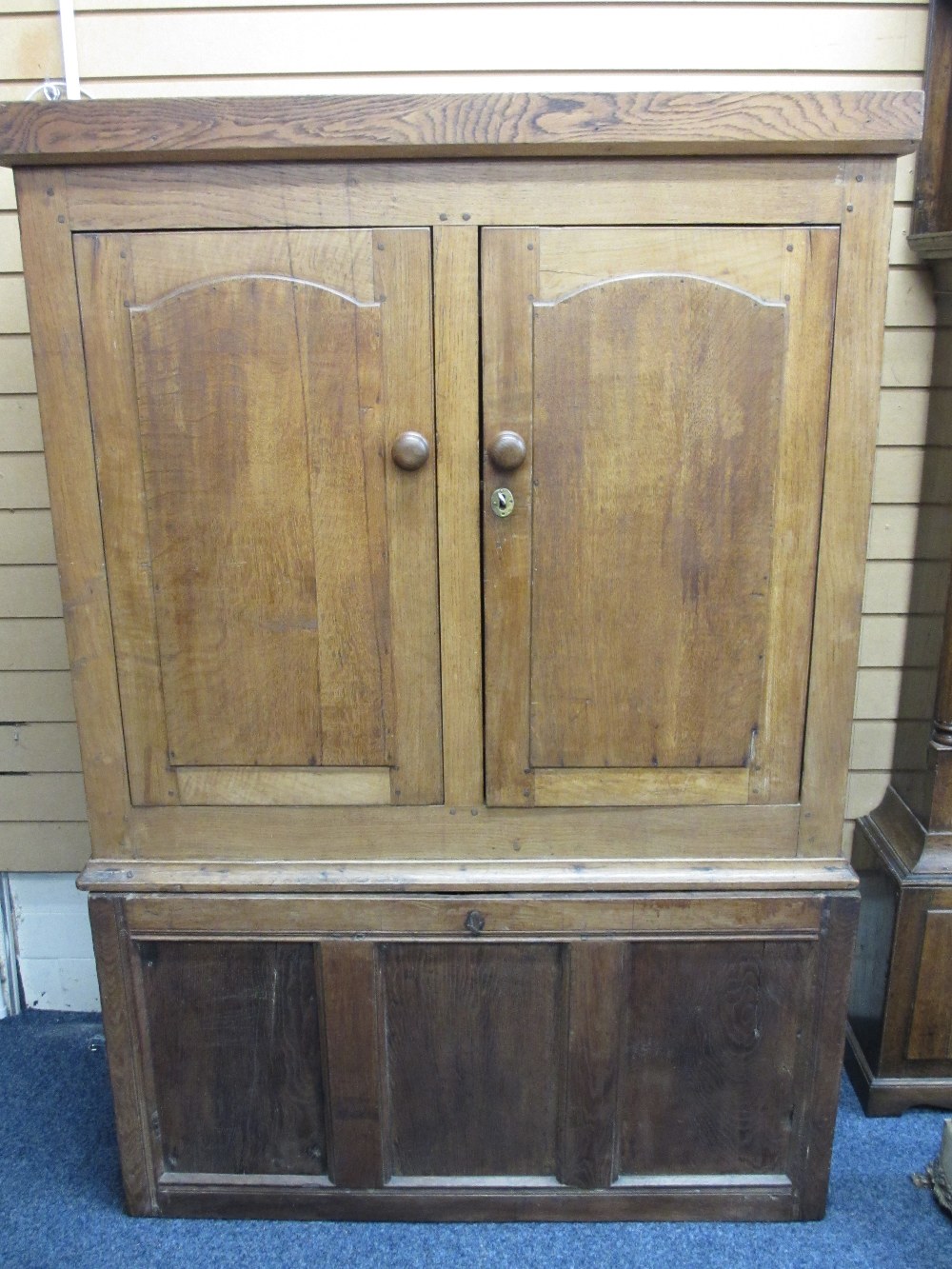 CIRCA 1820 OAK PRESS CUPBOARD, peg joined construction with shaped panel upper doors and panel sides