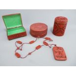 THREE CARVED CINNABAR TYPE LIDDED CONTAINERS and a necklace, various measurements