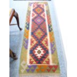 MAIMANA KILIM RUNNER - green and red ground with multicolour central diamond pattern and wave
