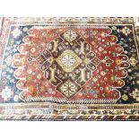 TRADITIONAL EASTERN STYLE RUG - blue and red ground with repeating central block pattern and multi-