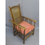 VINTAGE RECLINING ELBOW CHAIR with cane seat and back, bobbin and twist detail