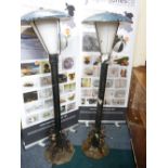 TWO GARDEN/STREET STYLE LAMPS in cast galvanized and wrought iron metal with domed top lamp covers