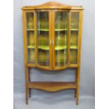 EDWARDIAN CHINA CABINET with convex central glazed doors, lower shelf, railback top and inlaid