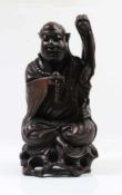 Figur.China, 19. Jh. Holz geschnitzt, sitzender Chinese. H: 32,5 cm.